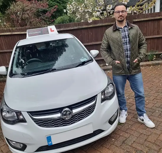 Jo Langford - DVSA approved driving instructor standing next to a red driving school car in Camberley, Surrey